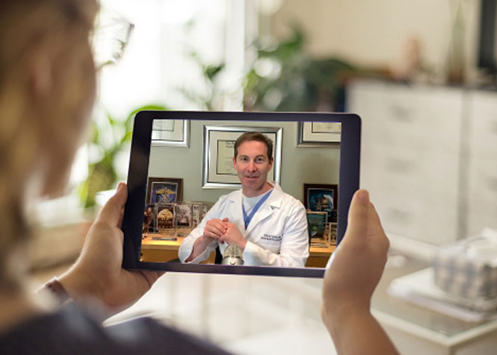 person on telehealth phone with doctor